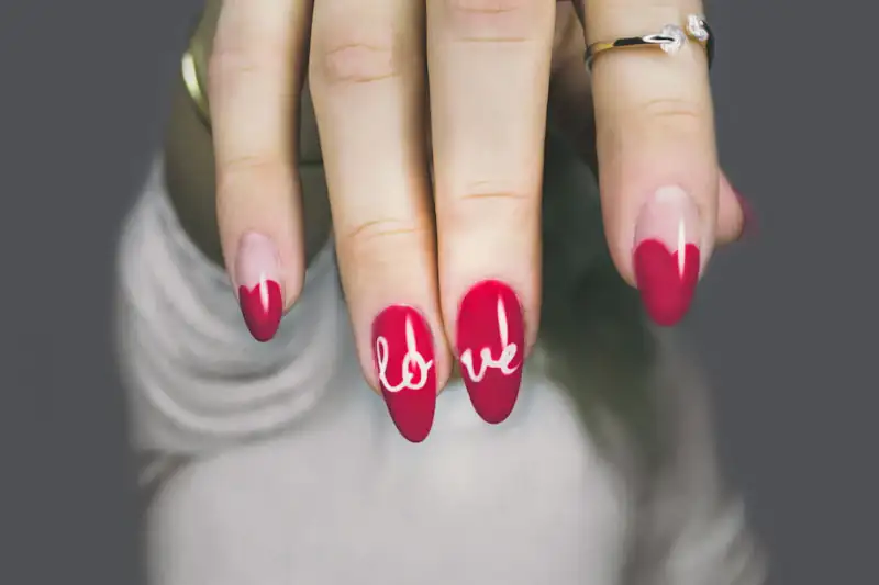 Pink manicure with hand-lettered design